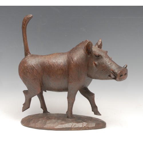 3247 - An amusing carved hardwood warthog, running with tail raised, 31cm high, 31cm wide, early 20th centu... 