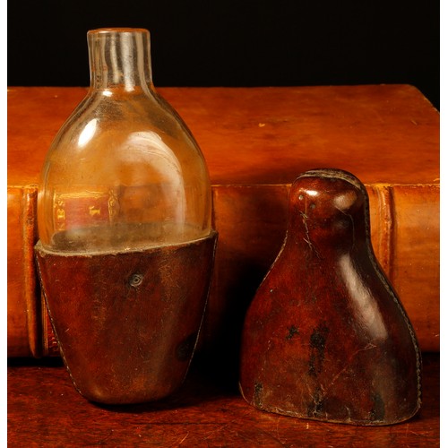 3593 - A 19th century leather travelling flask, push-fitting cover enclosing a clear glass bottle, 17.5cm l... 