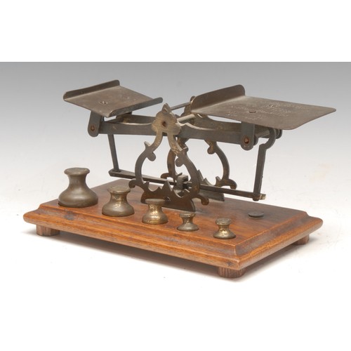 3200 - A set of Victorian oak and brass letter balance scales, the large plateau inscribed Postage Rates, L... 