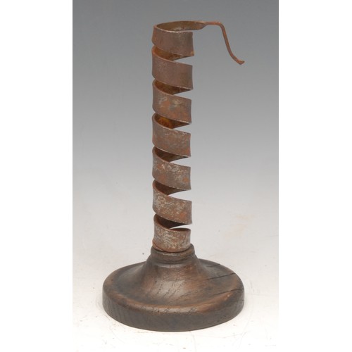 3336 - An iron spiral candlestick, turned base, 20cm high