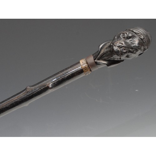 3708 - An early 20th century novelty walking stick, the pommel carved as the head of a dog wearing a jockey... 