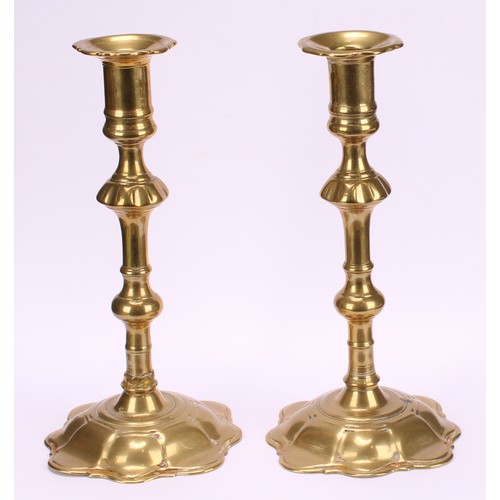 3618 - A pair of George II brass candlesticks, knopped pillars, domed shaped bases, 24cm high, c.1745