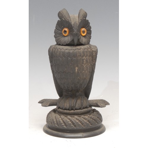 3508 - Treen - an Irish bog oak novelty box or inkwell, carved as an owl, glass eyes, 15.5cm high, early 20... 