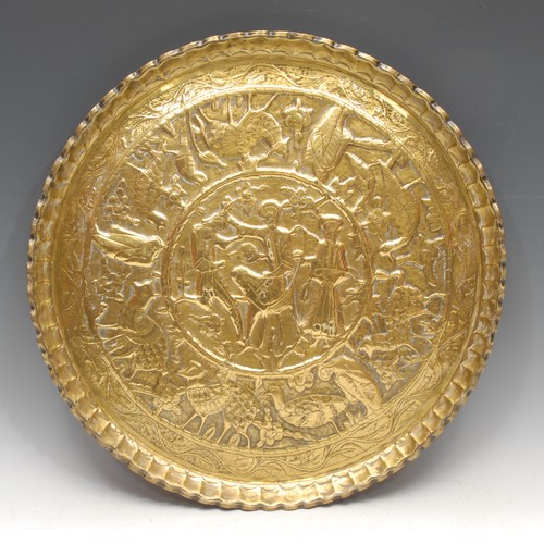 3125 - A North African circular brass charger or table top, decorated with Arabic script, animals and Egypt... 