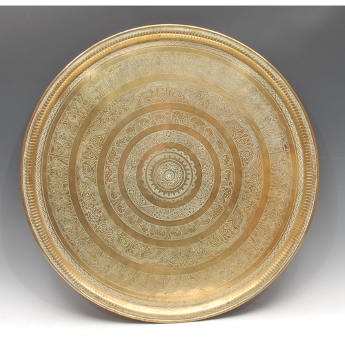 3125 - A North African circular brass charger or table top, decorated with Arabic script, animals and Egypt... 