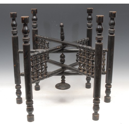 3112 - A Middle Eastern ebonised folding table, the brass tray top chased in the Islamic taste, Moorish bas... 