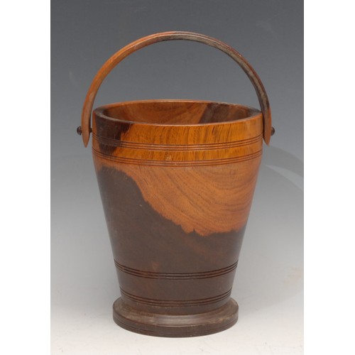 3504 - Treen - a turned lignum vitae ice bucket, swing handle, 19cm high, early 20th century