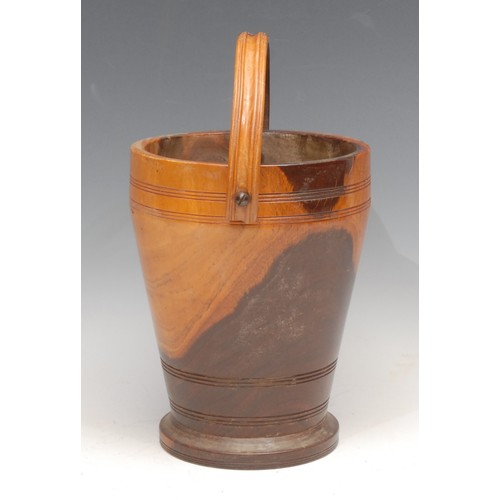 3504 - Treen - a turned lignum vitae ice bucket, swing handle, 19cm high, early 20th century