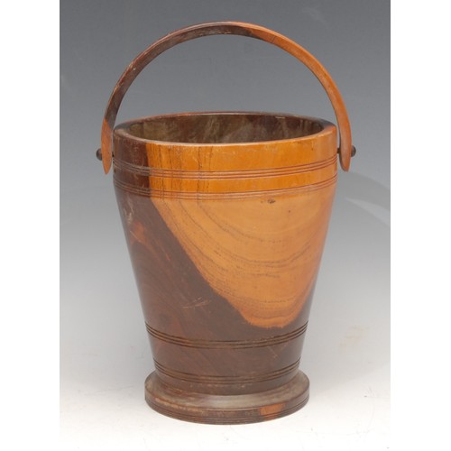 3504 - Treen - a turned lignum vitae ice bucket, swing handle, 19cm high, early 20th century