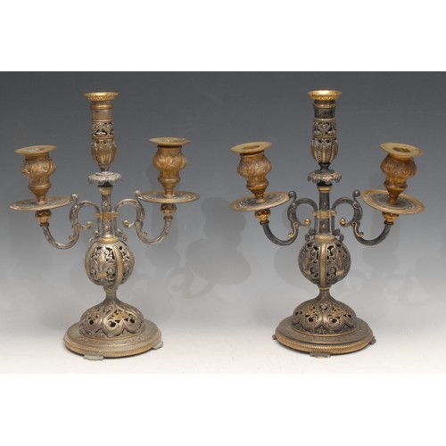 3146 - A pair of 19th century Renaissance Revival parcel-gilt and silvered bronze three-light candelabra, p... 
