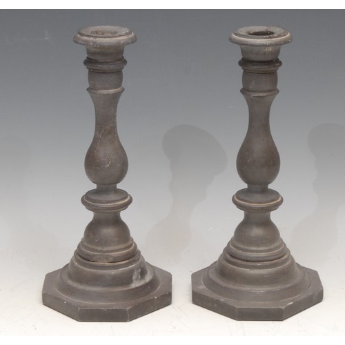 3147 - A pair of 19th century slate candlesticks, probably Welsh, campana sconces, knopped baluster pillars... 