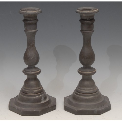 3147 - A pair of 19th century slate candlesticks, probably Welsh, campana sconces, knopped baluster pillars... 