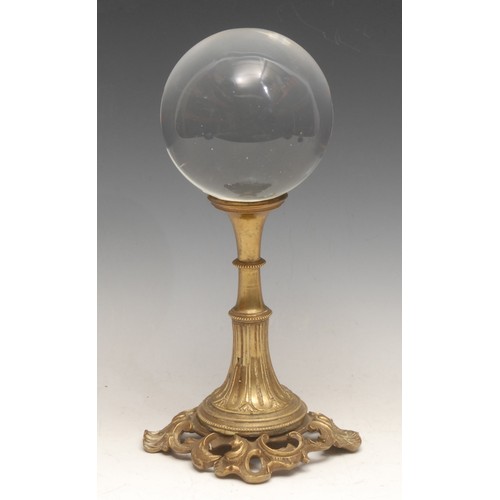 3463 - Mysticism and the Occult - a crystal ball, early 20th centtury gilt metal pedestal stand, 28cm high ... 