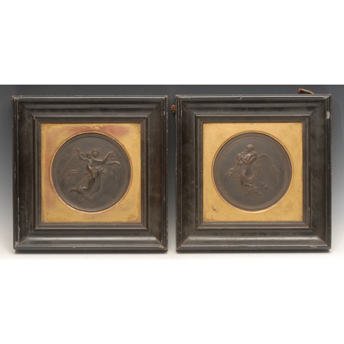 3143 - A pair of 19th century Neo-Classical dark patinated bronze roundels, cast in bas relief with Cupid a... 