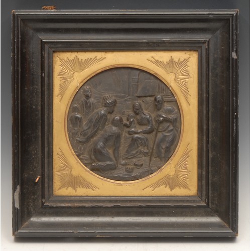 3554 - A 19th century dark patinated bas relief roundel, cast with the Adoration of the Magi, gilt slip, eb... 