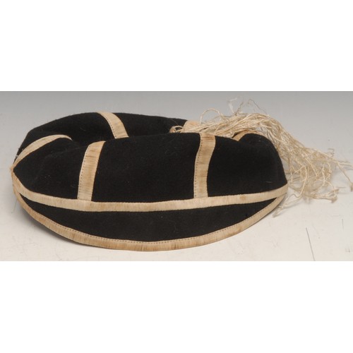 3480 - Sport - an early 20th century Rugby cap, labelled Sold by Wellington College Shop, 18cm diam