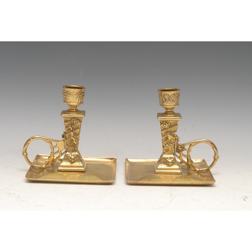 3149 - A pair of Arts & Crafts period brass chambersticks, in the Aesthetic Movement taste with insects and... 