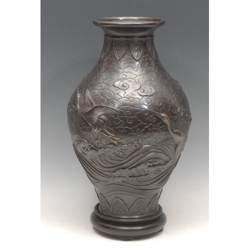 3407 - Genryusai Seiya (1868-1912), a Japanese dark patinated bronze ovoid vase, cast in relief with cranes... 