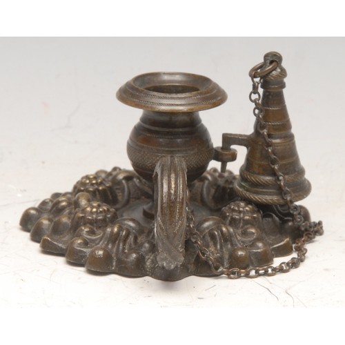 3176 - A post-Regency bronze chamberstick, cast with leaves and flowerhead bosses, conical snuffer, loop ha... 