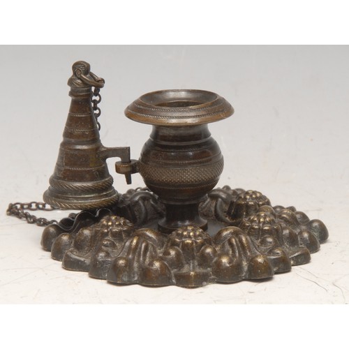 3176 - A post-Regency bronze chamberstick, cast with leaves and flowerhead bosses, conical snuffer, loop ha... 