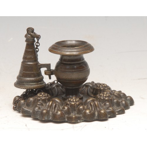 3176 - A post-Regency bronze chamberstick, cast with leaves and flowerhead bosses, conical snuffer, loop ha... 