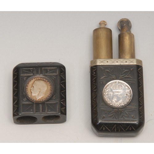 3315 - An early 20th century vulcanite type cigarette lighter, set with 3d coins, 7.5cm long