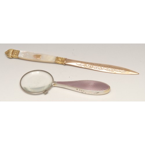 3579 - A 19th century gilt metal and mother of pearl letter knife, 21.5cm long; a silver and guilloche enam... 