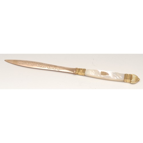 3579 - A 19th century gilt metal and mother of pearl letter knife, 21.5cm long; a silver and guilloche enam... 
