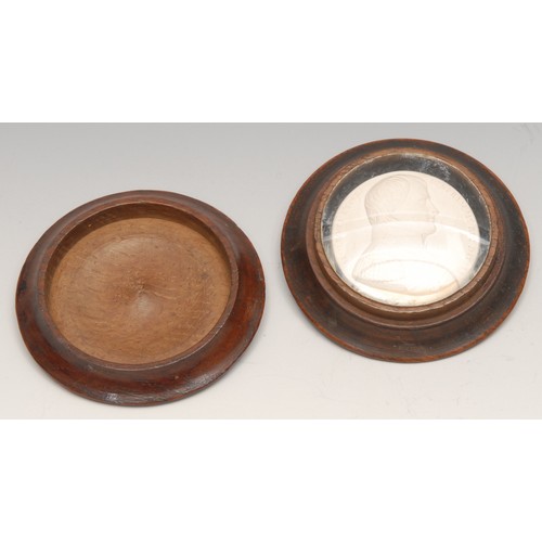 3499 - Treen - a 19th century turned oak circular box, the push-fitting cover now enclosing a plaster intag... 