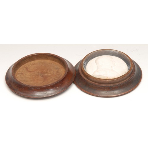 3499 - Treen - a 19th century turned oak circular box, the push-fitting cover now enclosing a plaster intag... 