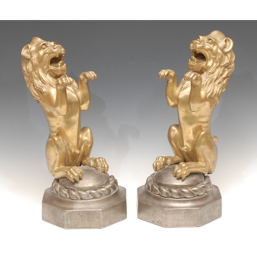 3150 - A pair of brass heraldic lions, each mounted on octagonal cast iron base, 35cm high, late 19th centu... 