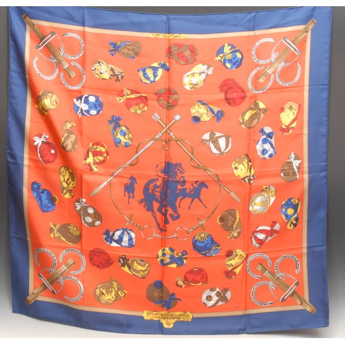 3620 - An Hermes silk scarf, Hong Kong Jockey Club, designed by Ledoux, printed with jockey caps and stirru... 