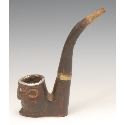 3246 - An African pipe, the bowl carved as a tribal mask, the features picked out in metal, 16cm long overa... 