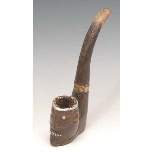 3246 - An African pipe, the bowl carved as a tribal mask, the features picked out in metal, 16cm long overa... 