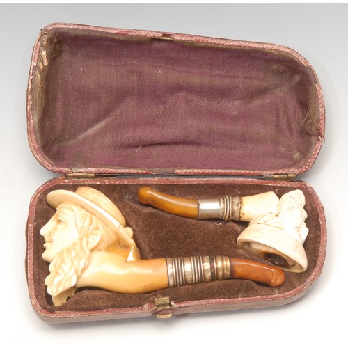 3137 - A pair of 19th century German novelty meerschaum pipes, each carved as the head of a sailor, the lar... 