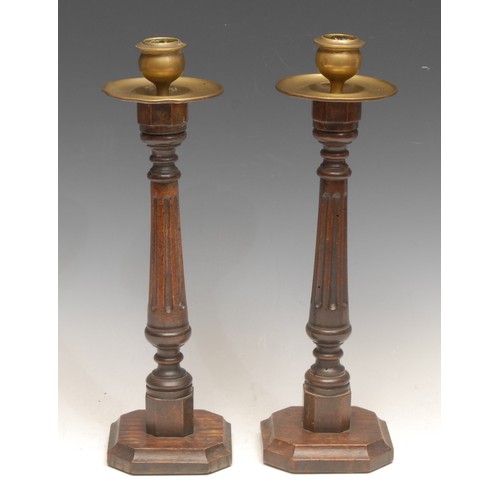 3155 - A pair of early 20th century candlesticks, brass sconces and drip pans, fluted pillars, canted squar... 