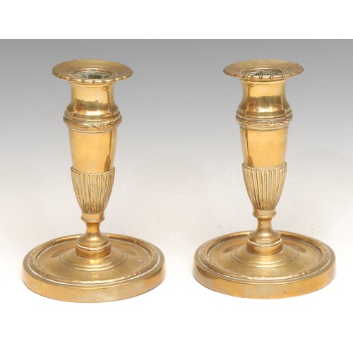 3135 - A pair of 19th century French brass boudoir candlesticks, fluted socles, circular bases, 13cm high, ... 