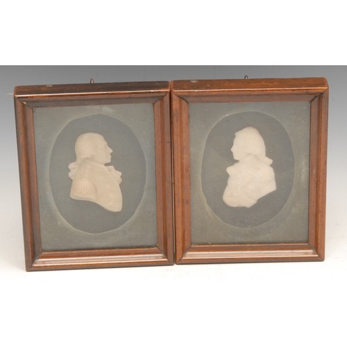 3148 - A pair of 19th century wax portraits, bust-length, facing to dexter and sinister, mahogany frames, 1... 