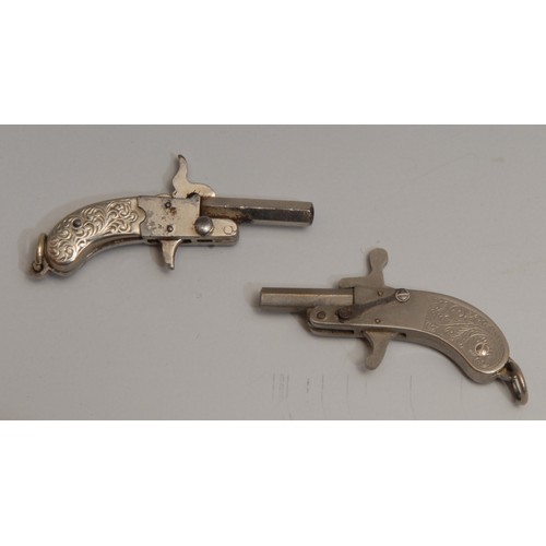 3300 - An early 20th century novelty watch fob pistol, hexagonal barrel, two-piece grip chased with scrolli... 