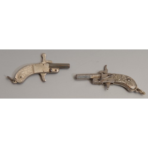 3300 - An early 20th century novelty watch fob pistol, hexagonal barrel, two-piece grip chased with scrolli... 