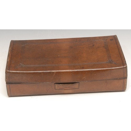 3293 - An early 20th century leather gentleman's dressing case, hinged cover enclosing an arrangement of ac... 