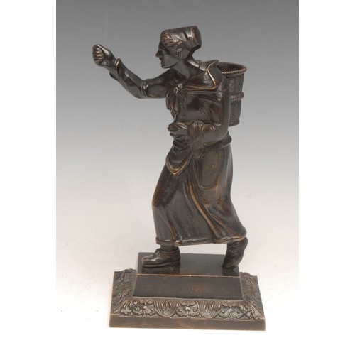 3538 - A 19th century bronze novelty figural table vesta, cast as a lady carrying a wicker hod, rectangular... 