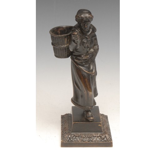 3538 - A 19th century bronze novelty figural table vesta, cast as a lady carrying a wicker hod, rectangular... 