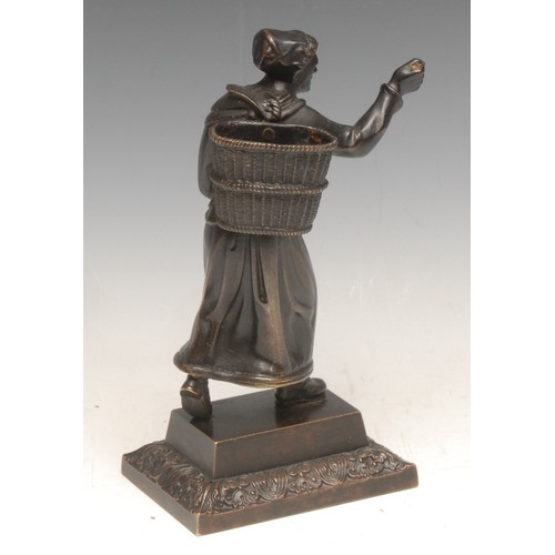 3538 - A 19th century bronze novelty figural table vesta, cast as a lady carrying a wicker hod, rectangular... 