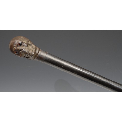 3711 - The Macabre - a bronze mounted novelty walking stick, the pommel as a skull, glass eyes, ebonised ca... 