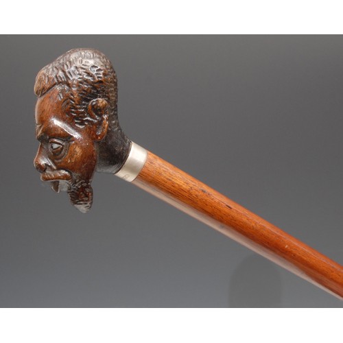 3709 - An early 20th century novelty walking stick, the pommel carved as the head of a man of African desce... 