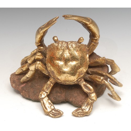 3366 - Continental School, a gilt bronze, of a crab, rustic stone base, 20cm wide