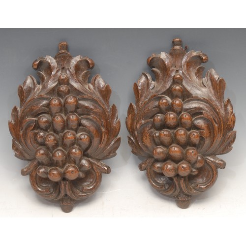 3144 - A pair of 19th century oak bosses, carved as fruiting vine, 22cm long, 14cm wide