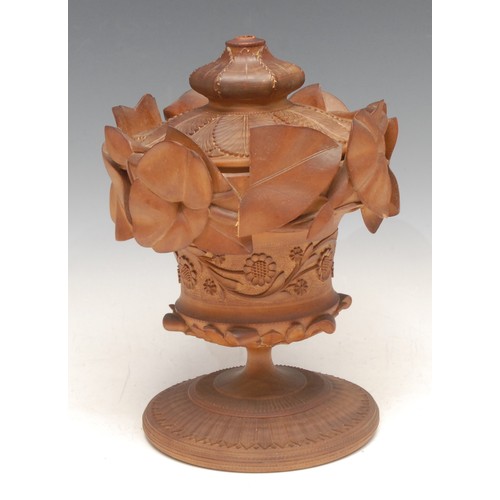 3332 - An Indian sandalwood pedestal jar and cover, carved with flowers, leafy vines and lotus, 21cm high, ... 