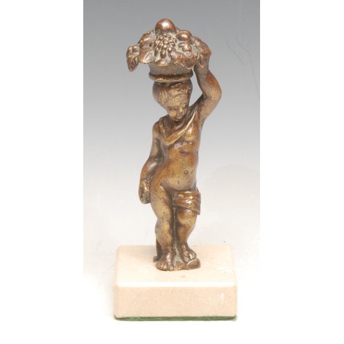 3549 - A 19th century continental bronze figure of a standing putto, balancing a basket of fruit on its hea... 